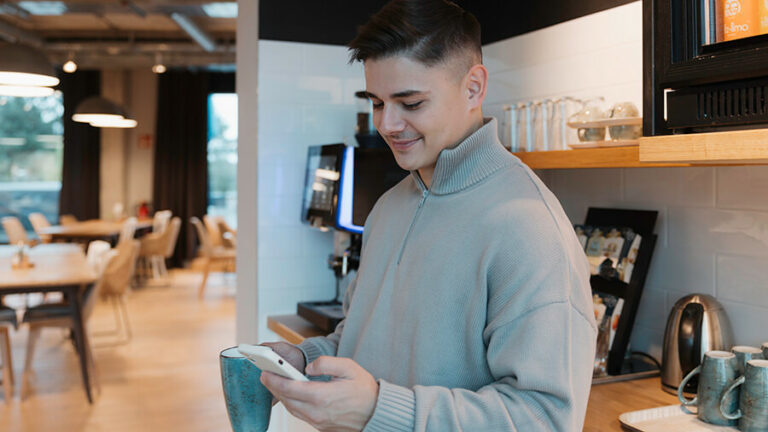 Person in der Küche am Handy